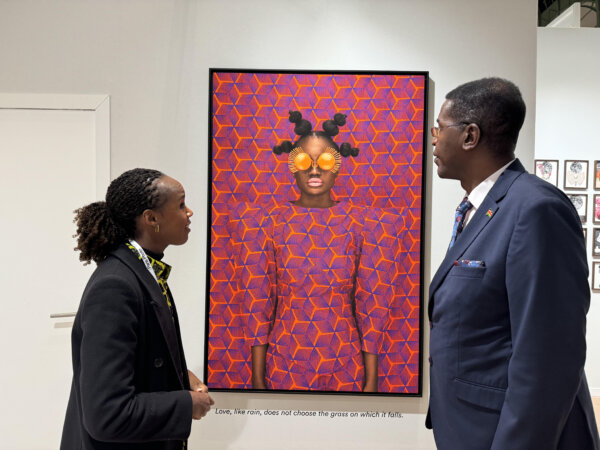 Amb. Peter Ngure admires one of Ms. Thandiwe's artwork at a recent show in Paris